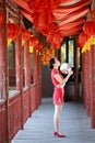 Happy Chinese bride in red cheongsam at traditional wedding day