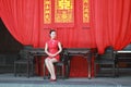 Happy Chinese bride in red cheongsam at traditional wedding day