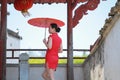 Happy Chinese bride in red cheongsam at wedding day