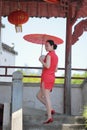 Happy Chinese bride in red cheongsam at wedding day