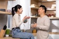 Happy chinese couple drinking coffee together at kitchen Royalty Free Stock Photo