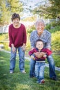 Happy Chinese Grandparents Having Fun with Their Mixed Race Grandson Outside Royalty Free Stock Photo