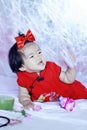 Happy Chinese little baby in red cheongsam have fun Royalty Free Stock Photo