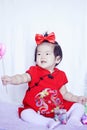 Happy Chinese little baby in red cheongsam have fun Royalty Free Stock Photo