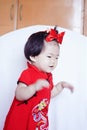 Happy Chinese little baby in red cheongsam have fun