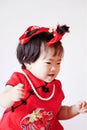 Happy Chinese little baby in red cheongsam have fun Royalty Free Stock Photo