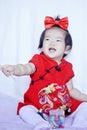 Happy Chinese little baby in red cheongsam have fun Royalty Free Stock Photo