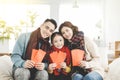 Happy chinese new year. asian family showing red envelope for lucky in living room Royalty Free Stock Photo