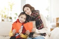 Happy chinese new year. asian mother and daughter showing red envelope for lucky in living room Royalty Free Stock Photo