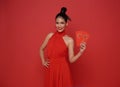 Happy Chinese new year. Asian woman wearing red dress holding angpao or red packet monetary gift with text means great luck, great