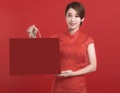 Happy chinese new year. Asian young Woman showing gift and holding  the shopping bag Royalty Free Stock Photo