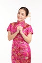 Happy Chinese new year, Beautiful young Asian woman wearing traditional cheongsam qipao dress with gesture of congratulation Royalty Free Stock Photo