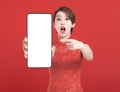 Happy chinese new year. excited young Woman showing blank smart phone screen Royalty Free Stock Photo