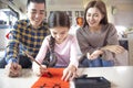 Happy chinese new year. family and little girl  writing calligraphy for celebration Royalty Free Stock Photo