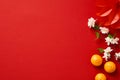 Happy Chinese New Year or lunar New Year concept. Festival decorations, mandarins, flowers on red background. Flat lay, top view Royalty Free Stock Photo