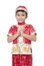 Happy Chinese new year.Young Asian boy with gesture of congratulation Royalty Free Stock Photo