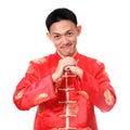 Happy Chinese new year.Young Asian man with gesture of congratulation on white background. Royalty Free Stock Photo