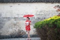 Happy Chinese woman in red cheongsam tour at ancient town