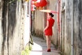 Happy Chinese woman in red cheongsam walk in the alley