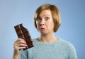 Happy chocolate addict woman holding big bar mouth stained and crazy excited face expression Royalty Free Stock Photo