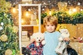 Happy Christmas child with teddy bear. Cute little kids celebrating Christmas. Christmas Celebration holiday. Royalty Free Stock Photo