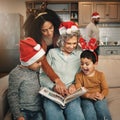 Happy, christmas and family looking at a photo album for memories, nostalgia and bonding. Smile, festive and mother