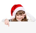 Happy Christmas girl with santa hat points down. isolated on white background Royalty Free Stock Photo