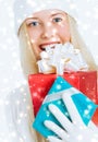 Happy Christmas and glitter snow background, happy blonde girl with gift boxes in winter season for shopping sale and