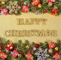 Happy christmas golden text and spruce branch and Christmas decorations Royalty Free Stock Photo