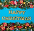 Happy christmas golden text and spruce branch and Christmas decorations Royalty Free Stock Photo