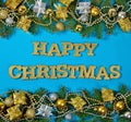 Happy Christmas golden text and spruce branch and Christmas decorations on a blue Royalty Free Stock Photo