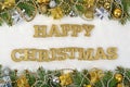Happy christmas golden text and spruce branch and Christmas decorations on a white Royalty Free Stock Photo