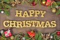 Happy christmas golden text and spruce branch and Christmas decorations Royalty Free Stock Photo