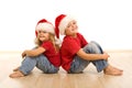 Happy christmas kids sitting on the floor Royalty Free Stock Photo