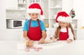 Happy christmas kids stretching the cookie dough Royalty Free Stock Photo