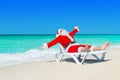 Happy Christmas Santa Claus on white beach bed at ocean beach Royalty Free Stock Photo