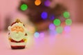 Happy christmas scene with a santa claus ornament and bokeh colorful lights. Royalty Free Stock Photo