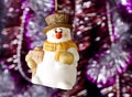 Happy Christmas snowman, tinsel as background. Royalty Free Stock Photo