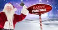 Happy Christmas text and Santa holding bell with Wooden signpost in Christmas Winter landscape Royalty Free Stock Photo