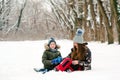 Happy christmas vacation. Young mother and son having fun in winter park. Family playing with snow outdoors Royalty Free Stock Photo