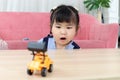 Happy chubby Asian girl with surprise expression face, portrait of surprised cute little toddler girl child looking at her toy in Royalty Free Stock Photo