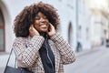 Happy, city and black woman listening to music, radio or song in the street while walking to work. Happiness, smile and Royalty Free Stock Photo