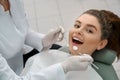 Happy woman lying in dentist chair, posing. Royalty Free Stock Photo