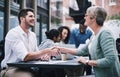 Happy clients lead to bigger profits. a businessman and businesswomen shaking hands during a meeting with colleagues. Royalty Free Stock Photo