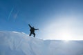 Happy climber with an ice ax in the snowy mountains.