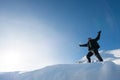 Happy climber with an ice ax in the snowy mountains