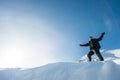 Happy climber with an ice ax in the snowy mountains.