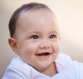 Happy, closeup face of a baby with a smile and health wellness for childhood development. Happiness or excited