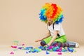 Happy clown boy with large colorful wig. Let`s party! Funny kid