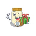 Happy coconut butter character having a gift box